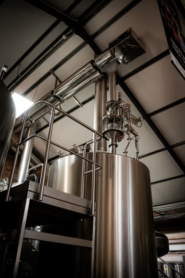 Looking up at a brew kettle and its pipework