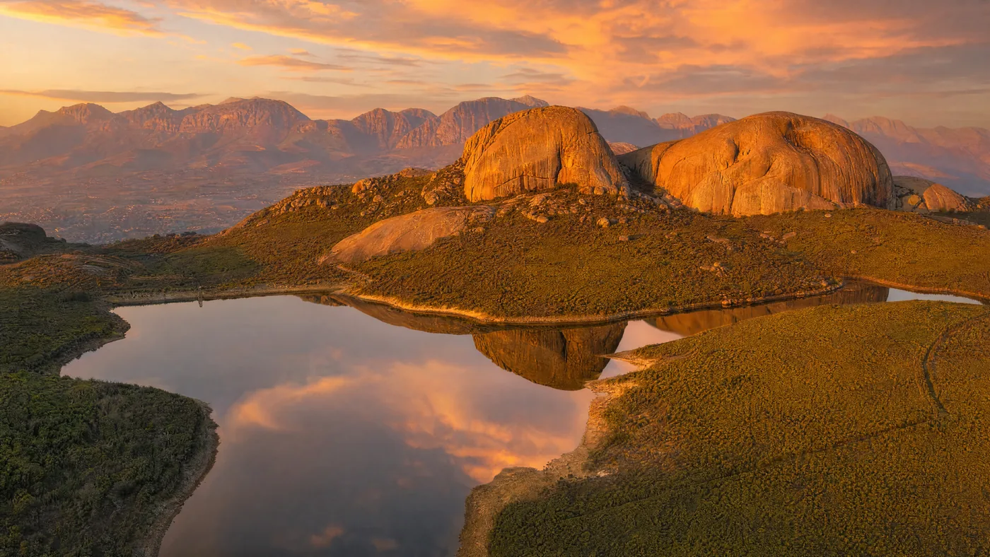 The dam in Paarl Mountain Nature Reserve at golden hour, with Paarl Rock and Bretagne Rock glowing behind the water