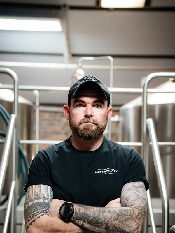 Anton Trollip, head brewer, arms crossed in the brewhouse
