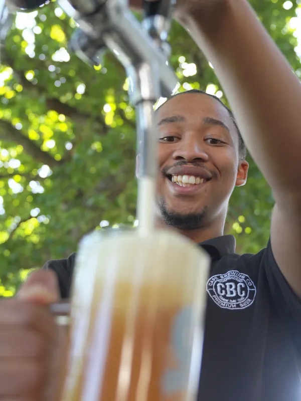 A smiling pour at the Oktoberfest bar