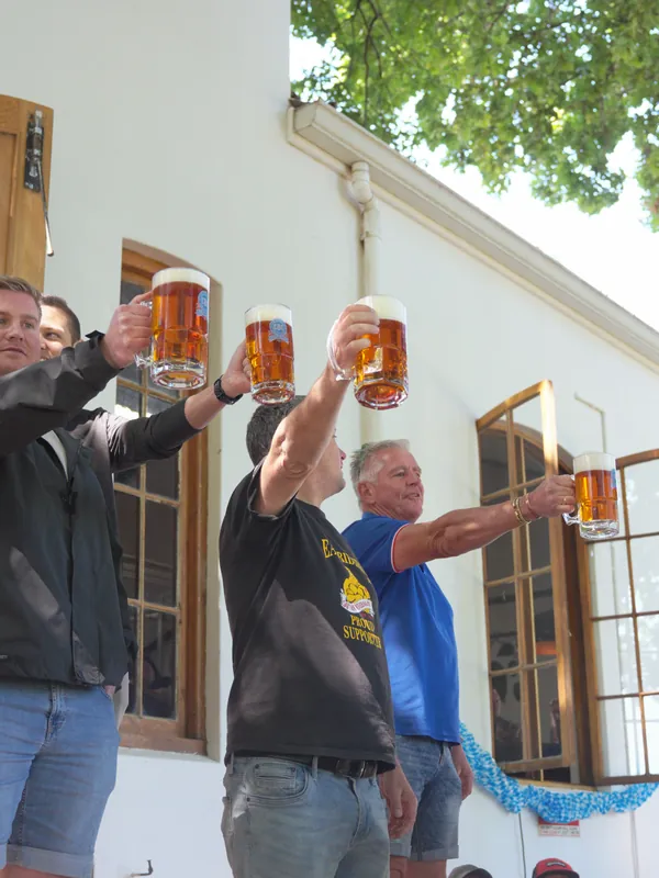 Guests hold their steins high in the stein-holding contest