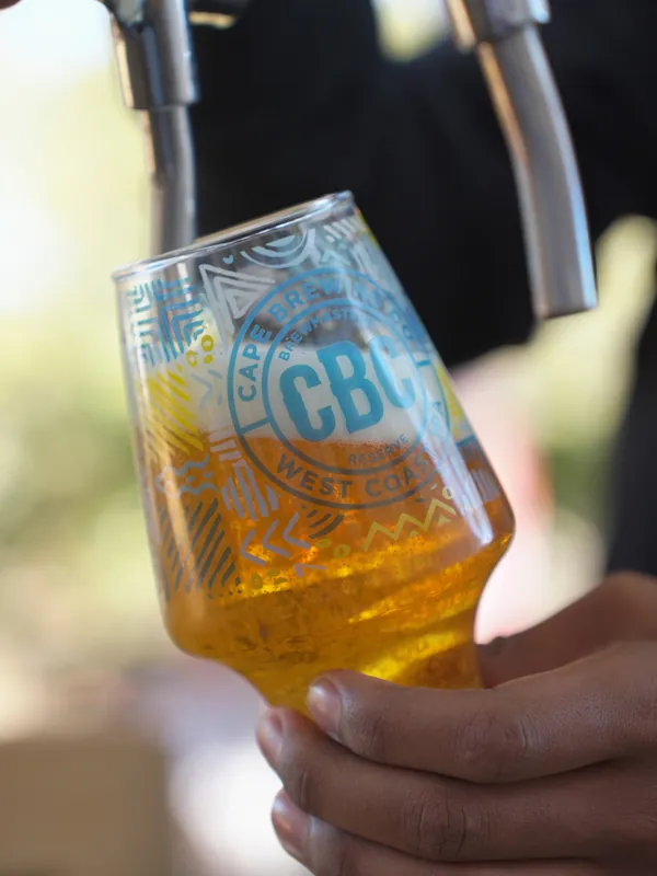 A glass of CBC in hand in the sun